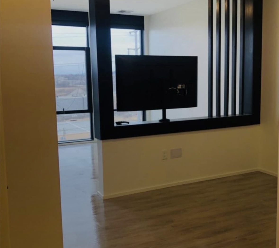 Completed apartment interior with painted walls, clean baseboard lines and a framed pass-through opening